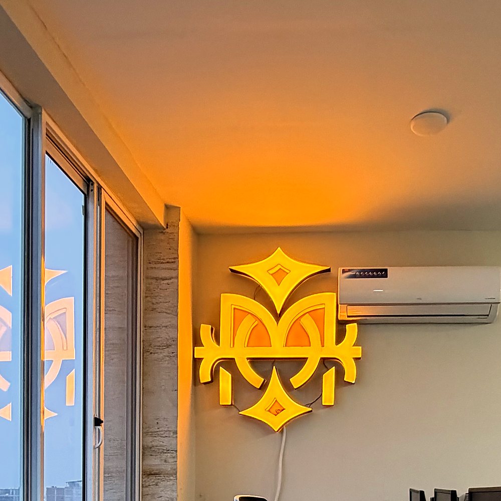 The Oakmount mark lit on the office wall